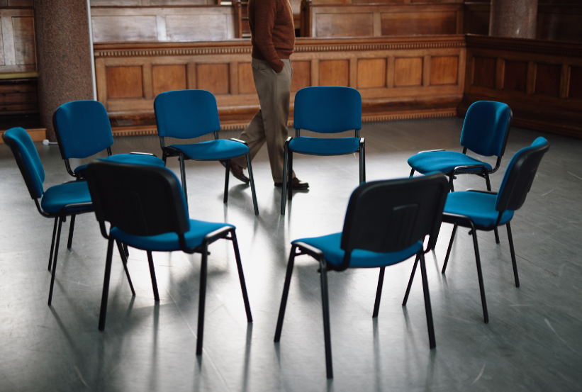 Empty chairs in a circle.